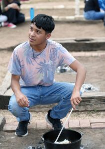 Ismael Juarez learned how to prepare a meal on an outdoor bed of coals similar to how one might be cooked on a cattle drive. – Submitted photo